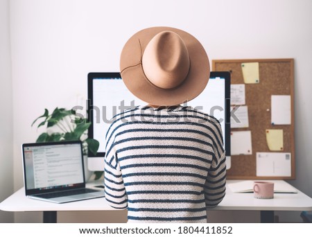 Woman working on computer at home office. Workplace, desk of creative worker. Modern remote work concept - self-employed freelancer, copywriter, designer. Distance education, student learning online.