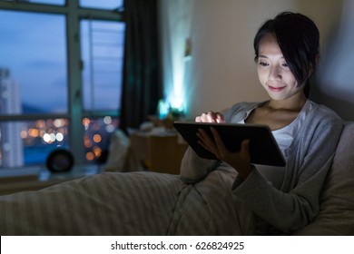 Woman Working On Digital Tablet Computer At Night