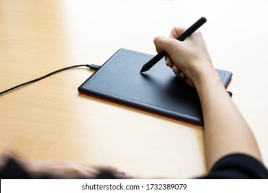 Woman Working On Electronic Drawing Board For Computer