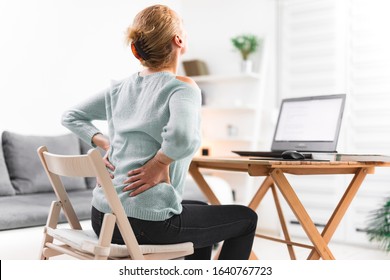 Woman Working On A Laptop And Having Back, Hip, Spine Pain.