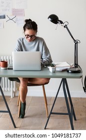 Woman Working On A Laptop In Her Home