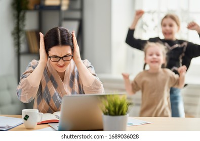 Woman Working On A Laptop. Noisy Children And Remote Work From Home.