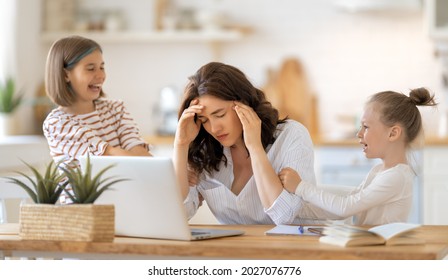 Woman Working On A Laptop. Noisy Children And Remote Work From Home. 