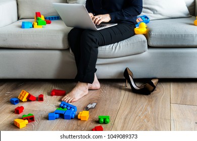 Woman Working On Laptop On Sofa