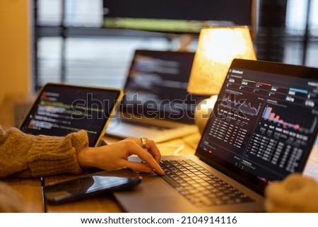 Woman working on some programming dashboard on laptop, close-up on hands and keyboard. Programmer, software tester or analyst working online