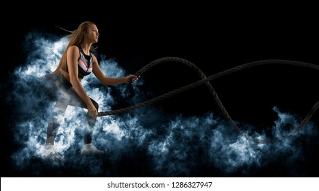 Woman working out with battle ropes. Fitness training 
