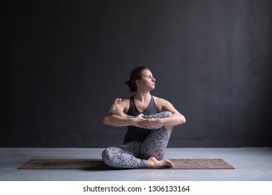 Woman Working Out, Doing Yoga Exercise On Floor, Needle Hip Stretch Pose