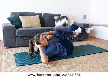 Woman Working Out at Home Doing Bicycle Crunches