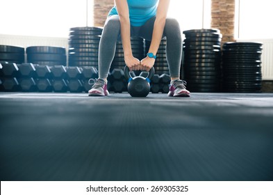 Woman Working Out With Kettle Ball At Gym