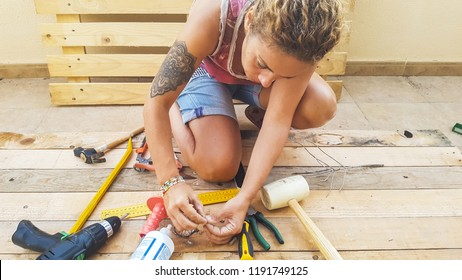 Woman Working Outdoor With Hardware Stuffs Building Furniture Or Something For Home With Recycled Pallets Pine Wood. Do It Yourself Hobby Concept