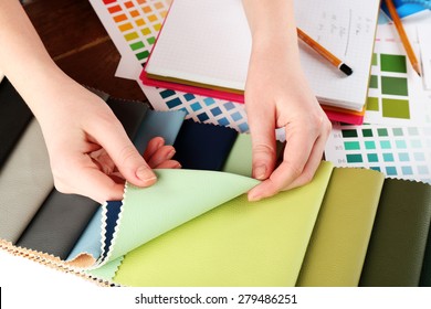 Woman working with scraps of colored tissue and palette close up