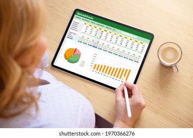 Woman working with spreadsheet document on tablet computer