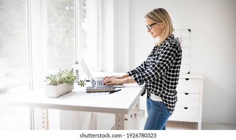 Woman Working At A Standing Desk In Office