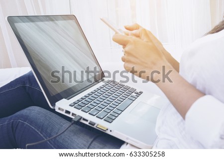woman working uses her smart phone and  laptop. Young Influencer millennial Using Social Media on Smartphone, Like, Follower, Comment and share on social. self absorbed new generation of young people