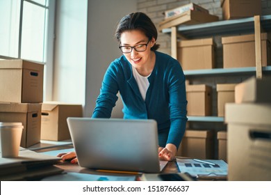Woman is working at warehouse for online seller. Concept of small web business.