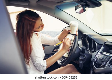 Woman working at the wheel in the car