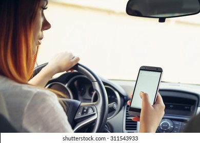 Woman Working At The Wheel In The Car. Don't Text And Drive
