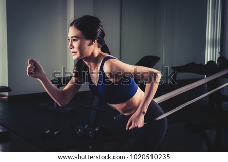 Woman workingout with Resistance elastic band in gym
