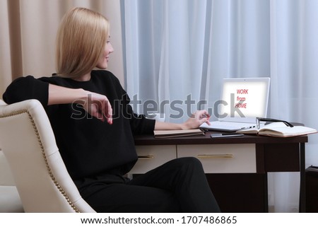 A woman works at a computer from home. Working in self-isolation or quarantine mode. An unrecognizable photo. Copy of the space.