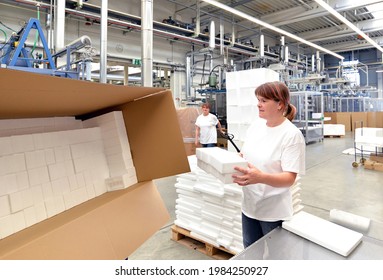 Woman Works In The Shipping Department Of A Company And Packs Styrofoam Components Into Packages For The Customer. 