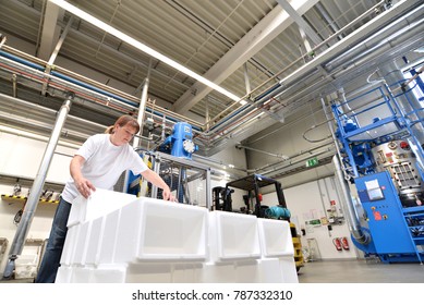 Woman Works In The Shipping Department Of A Company And Packs Styrofoam Components Into Packages For The Customer. 