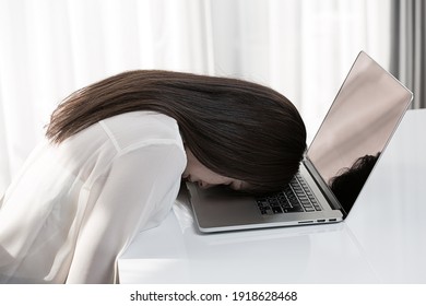 A Woman Is Worried About Having Her Head On A Laptop.