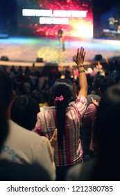 Woman Worshipping In Mega Church