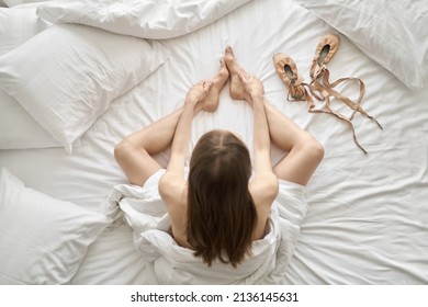 Woman wrapped in blanket posing on light bed - Shutterstock ID 2136145631