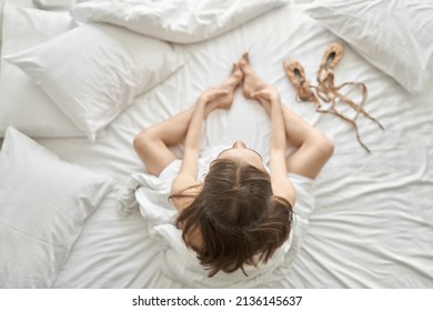 Woman wrapped in blanket posing on light bed - Shutterstock ID 2136145637