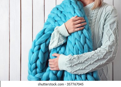 Woman Wrapped In Large Knitted Blanket