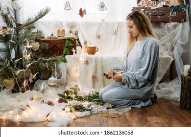 Woman Wrapping Christmas Gifts Near Xmas Tree At Home. Christmas Gift Boxes Wrapping Process. Female Hands With Christmas Gifts Boxes Wrapped In Kraft Paper In Natural Zero Waste Style.