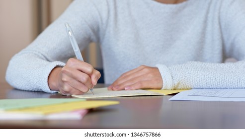 Woman write on note paper at home - Shutterstock ID 1346757866