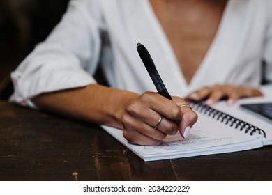 Woman Writing Down On Her Notebook