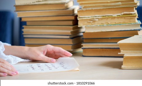 Woman Writing Essay Or Love Letters On A Piece Of White Paper In Library. Closeup Of Female Hands With Ring,  Writing Notes. Handwritten Text