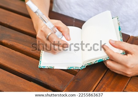 Woman writing gratitude journal in her relaxing recreation time. Mindfulness spiritual living lifestyle