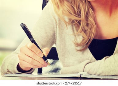 Woman writing in her notebook.