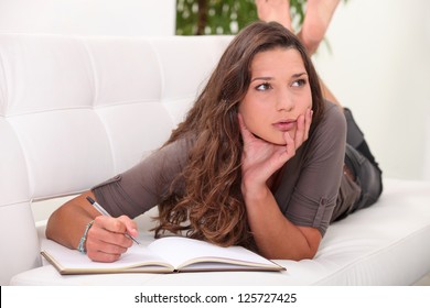 Woman Writing In A Journal