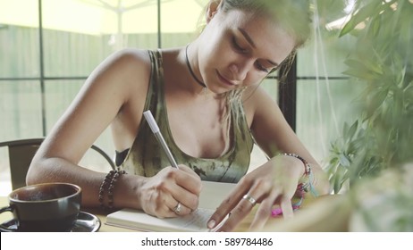 Woman Writing In Journal In Cafe, Working In Mobile Office