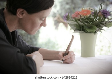 Woman Writing A Letter Left Handed