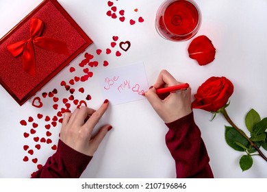 Woman Writing Love Letter For Valentines Day. Female Hands Write Writing Love Letter At The Desk, Top View