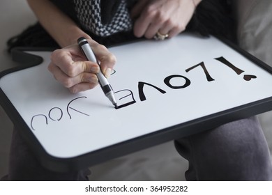 Woman writing I love you message white board  Love message writing selective focus