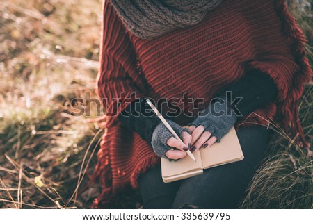 Woman writing in the notebook