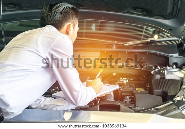 Woman\
writing on notepad or book, paper with car and blurry background.\
for note, transport, business, copy space\
image.
