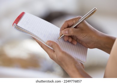 Woman writing on paper, using copybook, pen, making draft, accidently planning tasks. Waitress taking order, writing in notebook. Close up of female hands, cropped shot - Powered by Shutterstock