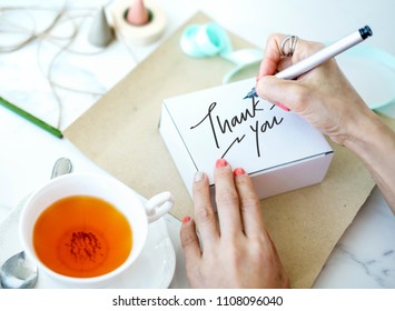 Woman Writing Thank You On A White Box