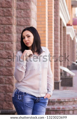 Woman XXL in casual clothes on the street in the city. Portrait plus size girls close-up.
