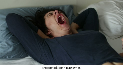 
Woman Yawning In Bed Morning. Real Life Authentic Person Yawn