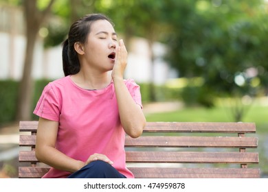 Woman Yawning At Garden