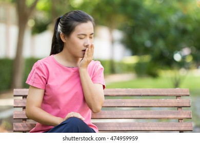 Woman Yawning At Garden