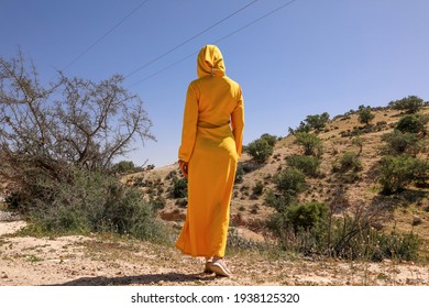 Woman In Yellow Djellaba In Nature.